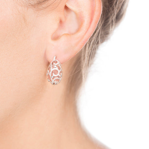 rose quartz and diamond studs on person